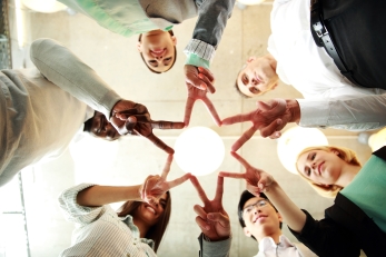 business and succcess concept - group of businesspeople showing v-sign together